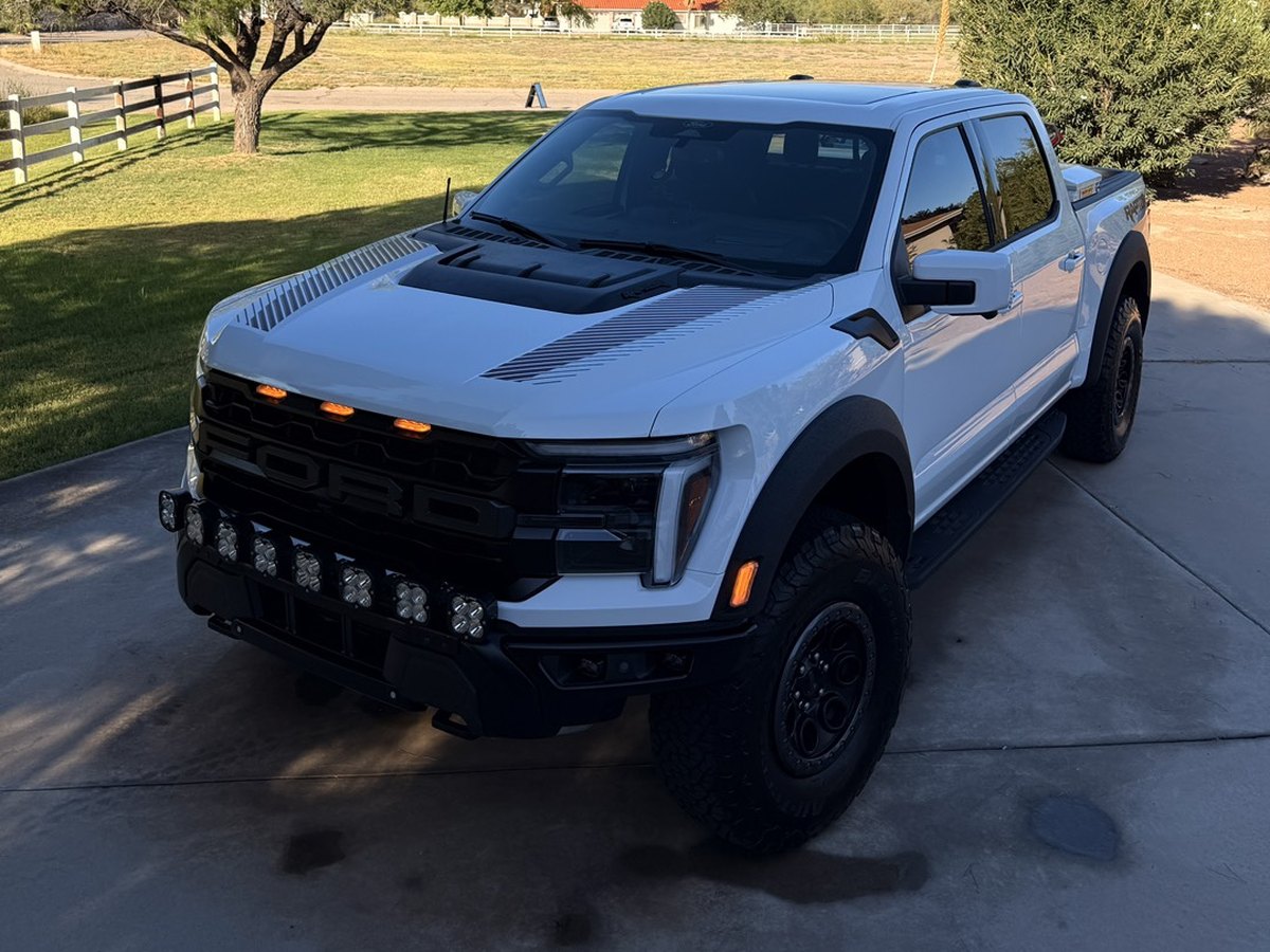 White Ford F-150 Raptor washed, dried and dressed on a driveway